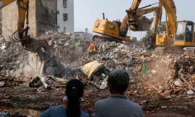 Residents of the damaged building stand as a damaged building is being demolished following the earthquake, in Hualien, Taiwan April 4, 2024. REUTERS/Tyrone Siu