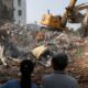 Residents of the damaged building stand as a damaged building is being demolished following the earthquake, in Hualien, Taiwan April 4, 2024. REUTERS/Tyrone Siu