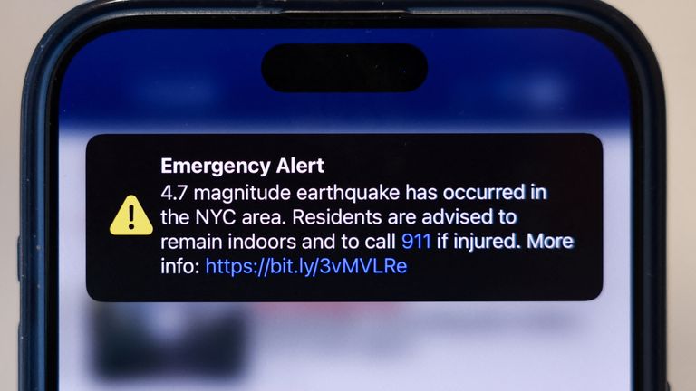 An emergency alert of a magnitude 4.7 earthquake is seen on a mobile phone in New York.
Pic: Reuters