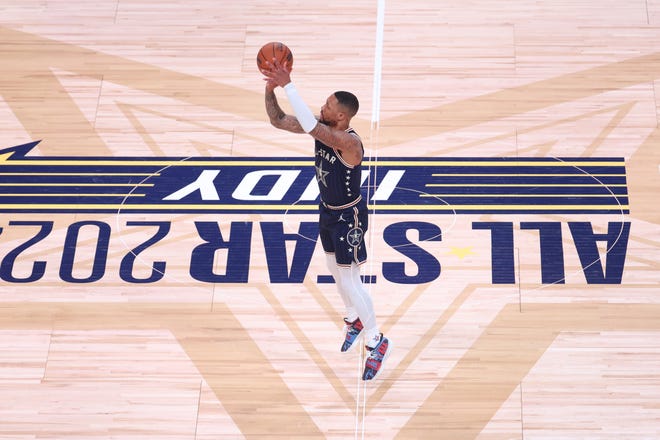 Eastern Conference guard Damian Lillard of the Bucks launches and makes a three-pointer from half court during the third quarter of the All-Star Game on Sunday night in Indianapolis.