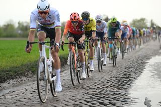 ROUBAIX FRANCE APRIL 07 LR Mathieu van der Poel of The Netherlands and Team Alpecin Deceuninck and Thomas Pidcock of The United Kingdom and Team INEOS Grenadiers compete passing through the Tilloy SarsetRosires cobblestones sector uring the 121st ParisRoubaix 2024 a 2597km one day race from Compiegne to Roubaix UCIWT on April 07 2024 in Roubaix France Photo by Dario BelingheriGetty Images