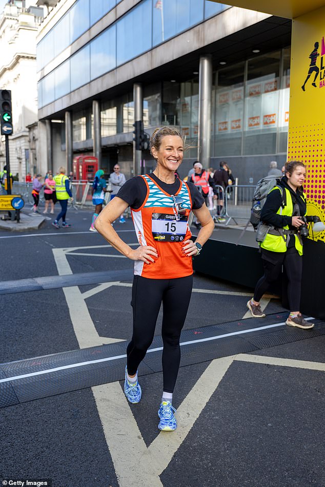 Lois chose to wear bright orange shorts and a black long sleeve gym top, with white running trainers