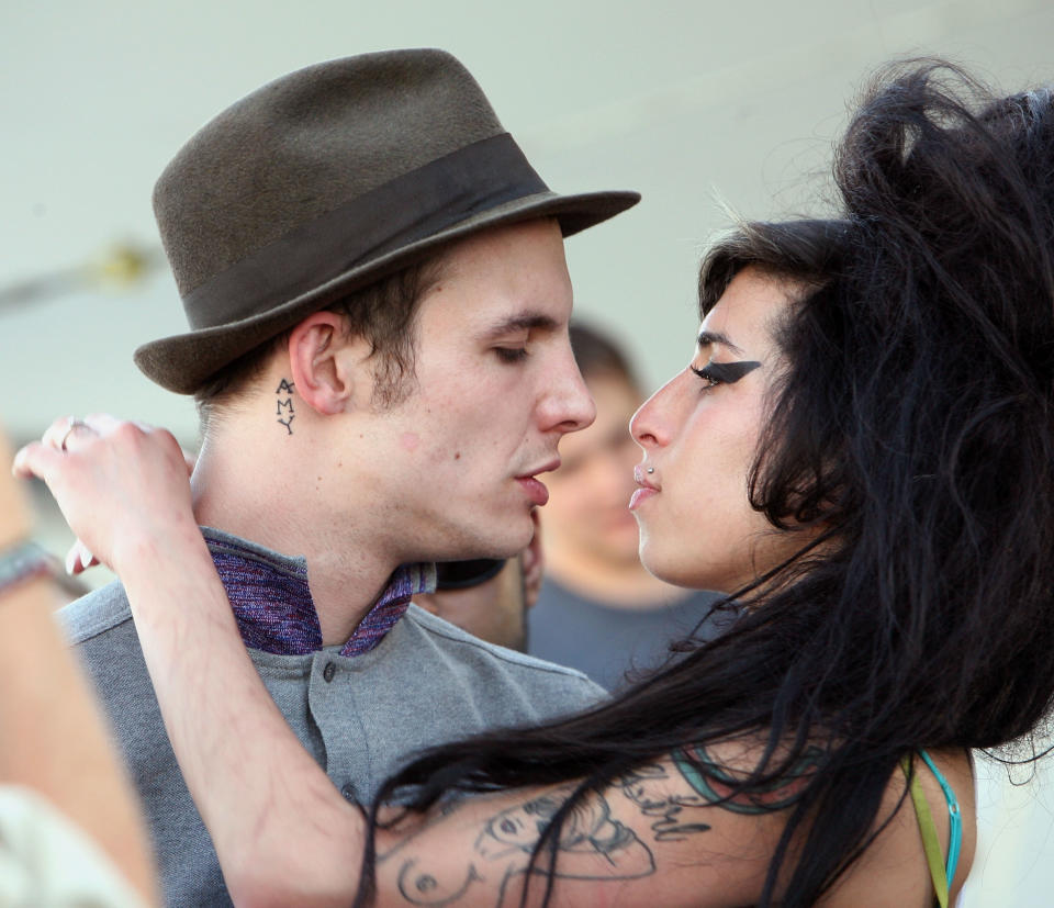 INDIO, CA - APRIL 27:  Singer Amy Winehouse kisses fiance Blake Fielder-Civil during day 1 of the Coachella Music Festival held at the Empire Polo Field on April 27, 2007 in Indio, California.  (Photo by Michael Buckner/Getty Images)