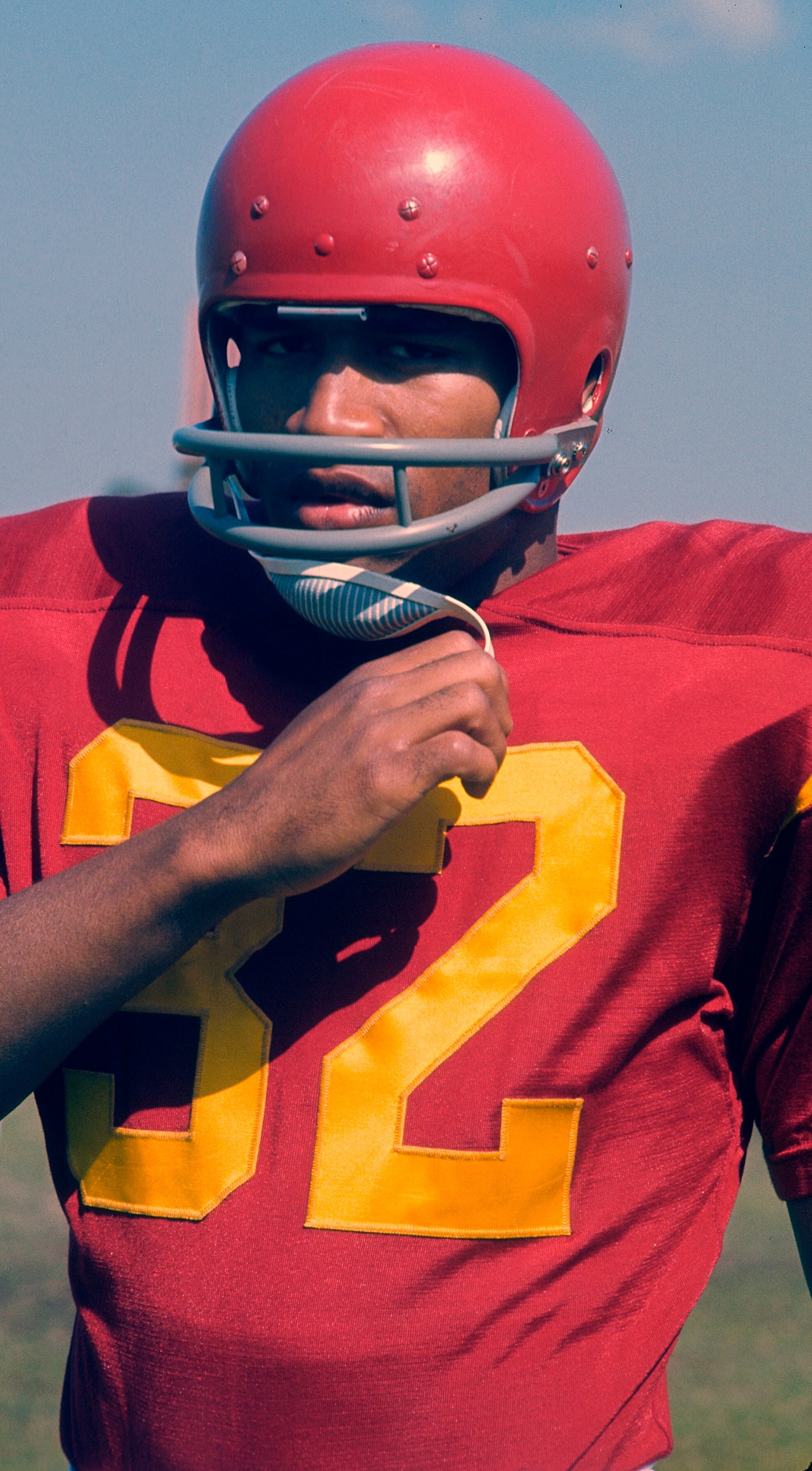 PHOTO: O.J. Simpson #32 of the University of Southern California Trojans looks on from the sidelines during an NCAA college football game circa 1968.