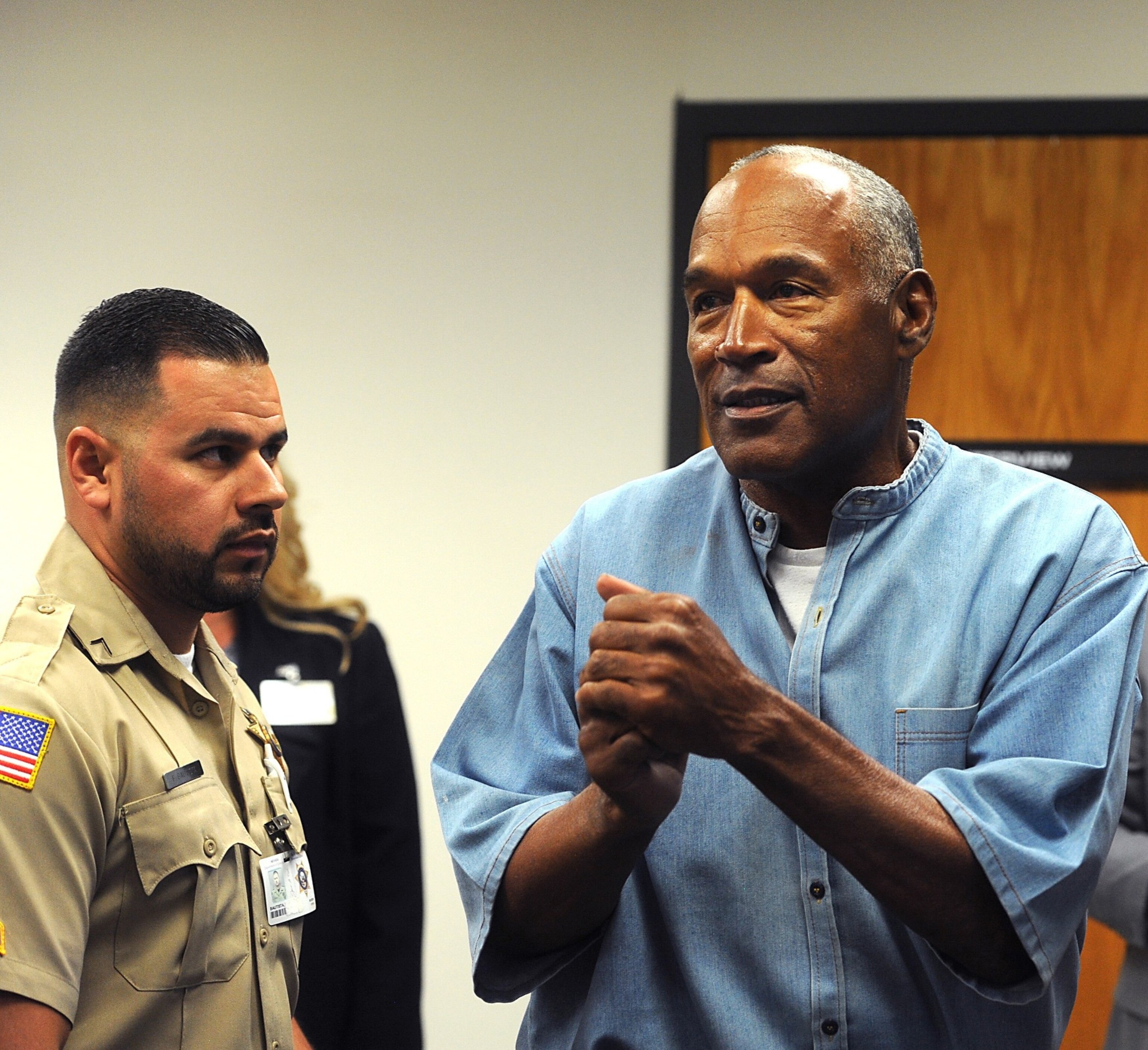 PHOTO: O.J. Simpson (C) reacts after learning he was granted parole at Lovelock Correctional Center July 20, 2017 in Lovelock, Nev.