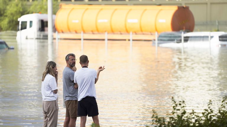 People look out at floodwater covering a major road in Dubai.
Pic: AP