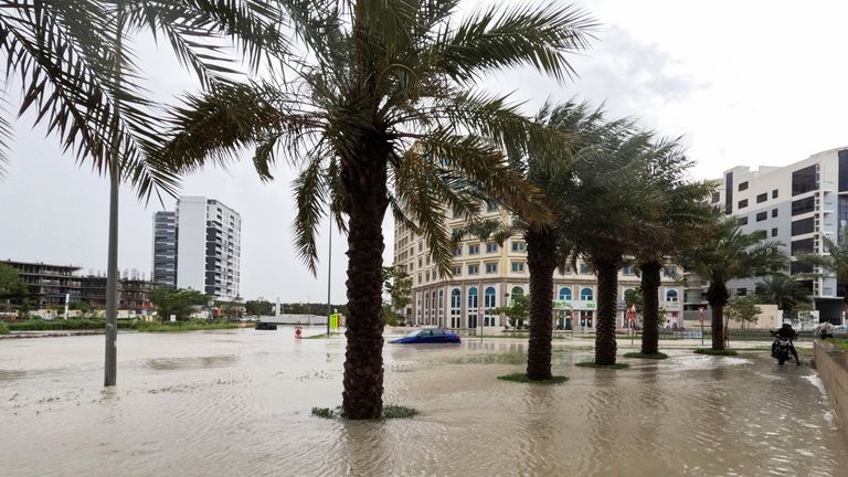 A person rides a motorcycle near a flooded street during a rain storm in Dubai.
Pic: Reuters