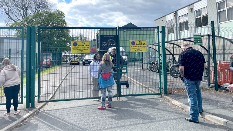 People talk through the gates at the scene of Amman Valley school, in Ammanford, Carmarthenshire.
Pic PA