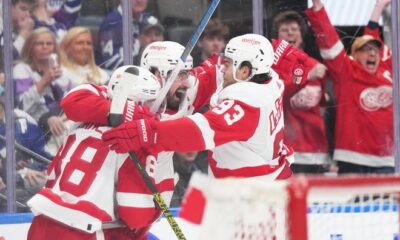 Red Wings center Dylan Larkin scores the winning goal and celebrates with right wing Alex DeBrincat (93) during the overtime period of the Red Wings' 5-4 win on Saturday, April 13, 2024, in Toronto.