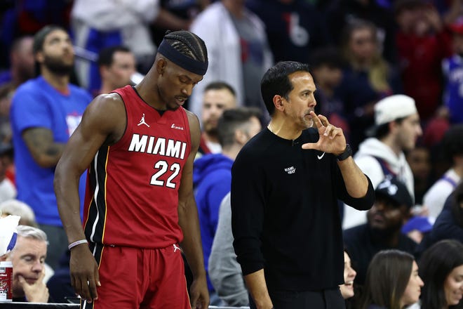 PHILADELPHIA, PENNSYLVANIA - APRIL 17: Head coach Erik Spoelstra and Jimmy Butler #22 of the Miami Heat during the fourth quarter against the Philadelphia 76ers during the Eastern Conference Play-In Tournament at the Wells Fargo Center on April 17, 2024 in Philadelphia, Pennsylvania. NOTE TO USER: User expressly acknowledges and agrees that, by downloading and or using this photograph, User is consenting to the terms and conditions of the Getty Images License Agreement. (Photo by Tim Nwachukwu/Getty Images)
