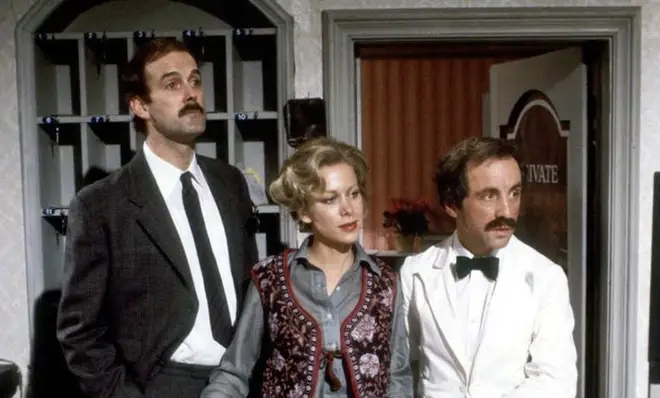 Cleese played slip-stick hotel owner Basil Fawlty (left) and his wife Connie Booth played hotel chambermaid, Polly Sherman (centre).