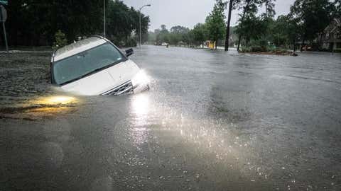 SPRING, TEXAS - MAY 2: An SUV is stranded in a ditch in a stretch of street flooding during a severe storm on Thursday, May 2, 2024 in Spring. (Brett Coomer/Houston Chronicle via Getty Images)