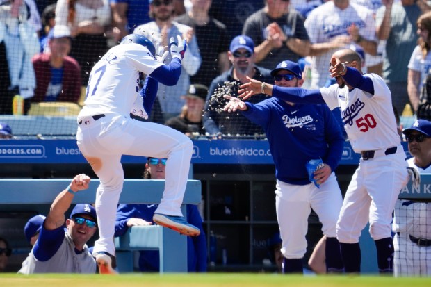 Los Angeles Dodgers’ Teoscar Hernández (37) celebrates with Max Muncy,...