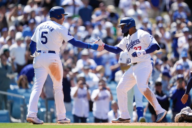 Los Angeles Dodgers’ Teoscar Hernández celebrates with Freddie Freeman (5)...