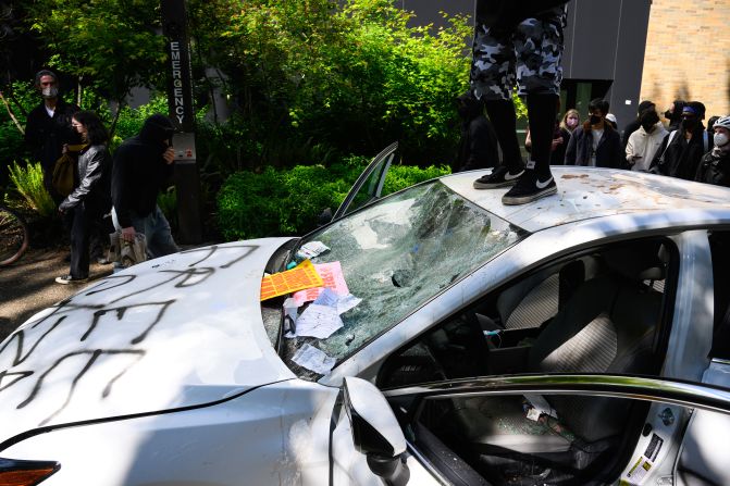 Protesters deface a automobile after a person <a href=