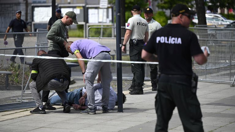 Pic: AP
Police arrest a man after Slovak Prime Minister Robert Fico was shot and injured following the cabinet's away-from-home session in the town of Handlova, Slovakia, Wednesday, May 15, 2024.  Fico is in life-threatening condition after being wounded in a shooting Wednesday afternoon, according to his Facebook profile. (Radovan Stoklasa/TASR via AP)