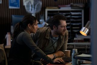 Lucie Shorthouse as Siobhan Clarke and Richard Rankin as John Rebus, hunched over a computer