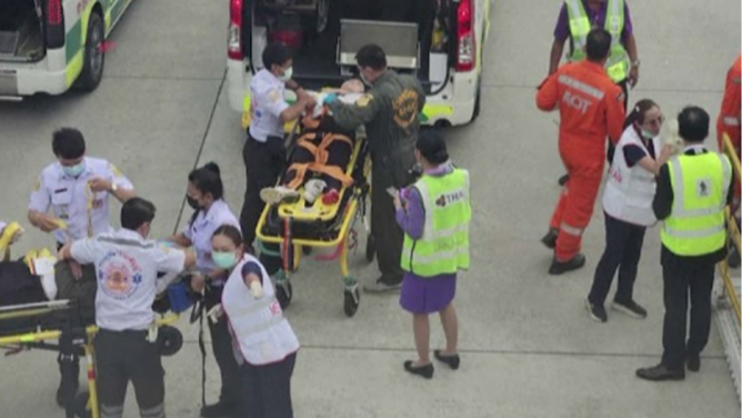 This photo shows injured passengers being loaded into an ambulance after a Singapore Airlines flight encountered severe turbulence on Monday, May 20, 2024.