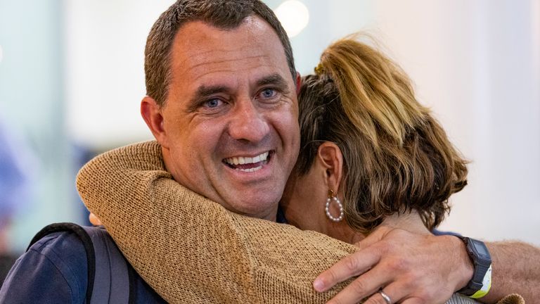 Chris Salmon is greeted by his wife after arriving from New Caledonia into Brisbane International Airport, in Brisbane, Australia,  
Pic: AAP/AP