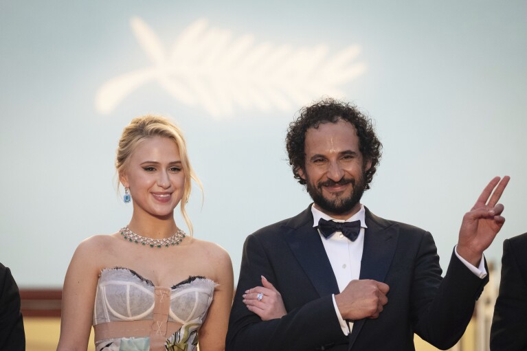 Maria Bakalova, from left, and director Ali Abbasi pose for photographers upon departure from premiere of the film 'The Apprentice' at the 77th international film festival, Cannes, southern France, Monday, May 20, 2024. (Photo by Scott A Garfitt/Invision/AP)