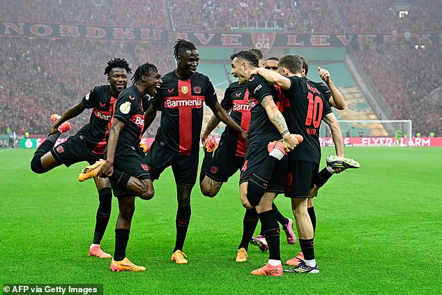 The players celebrate Xhaka's winning goal as they bag the German Cup to go with the league