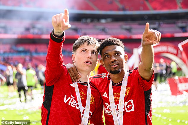 Amad Diallo (right) was moved out the way of oncoming Champagne in dressing room celebrations following the cup final win