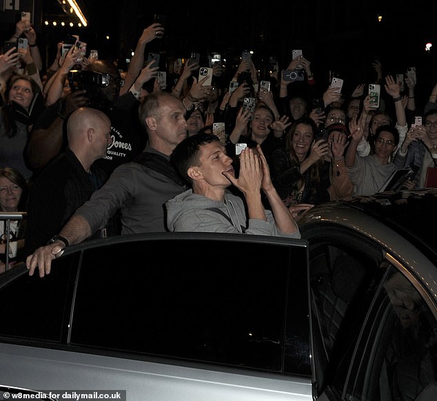 Tom Holland interacts with the huge crowd of fans waiting outside the Duke of York Theatre after the first preview of Romeo and Juliet on May 13 as he gets in a car to leave the venue