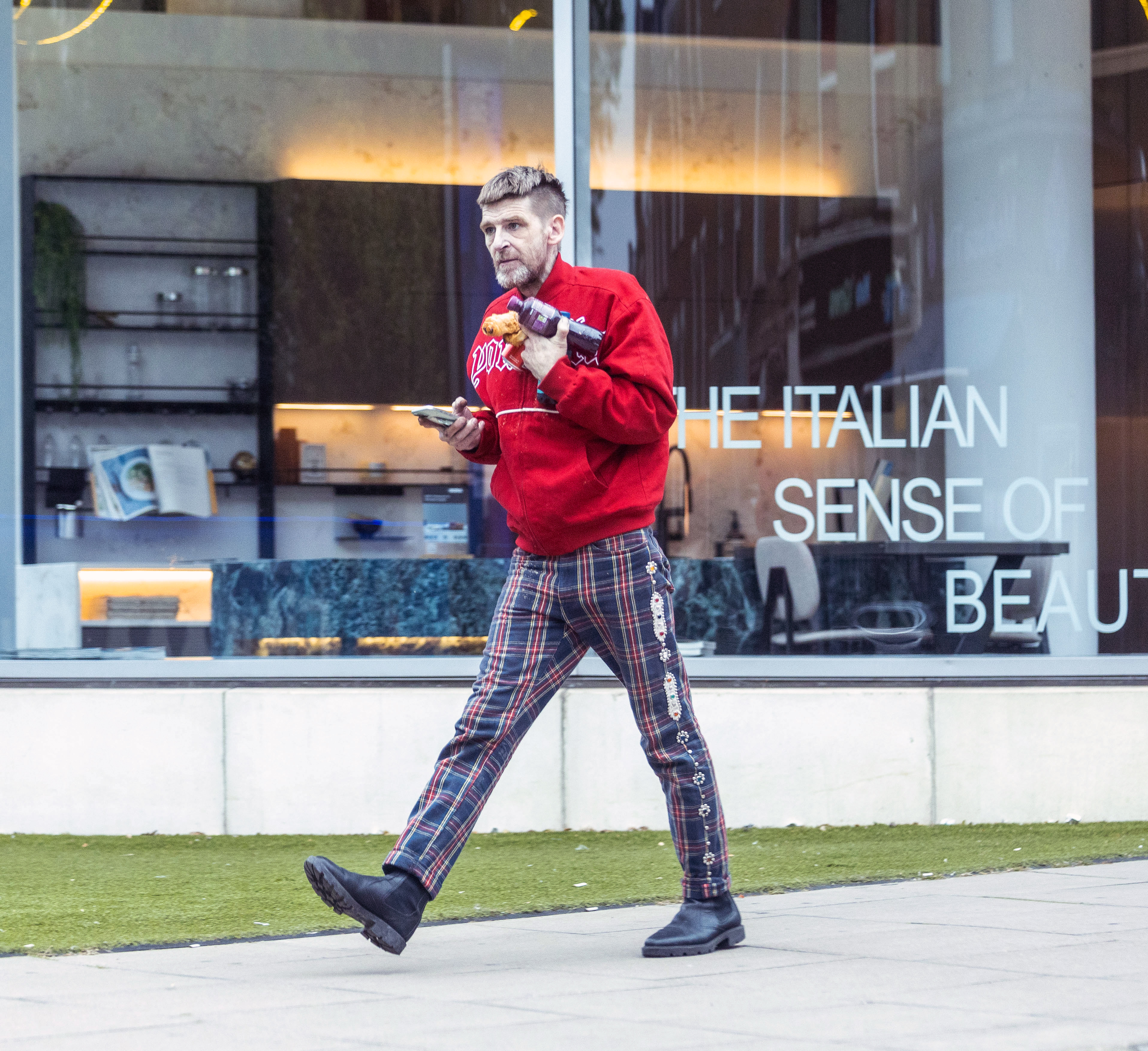 Later in the day, he switched to a red jersey and check trousers