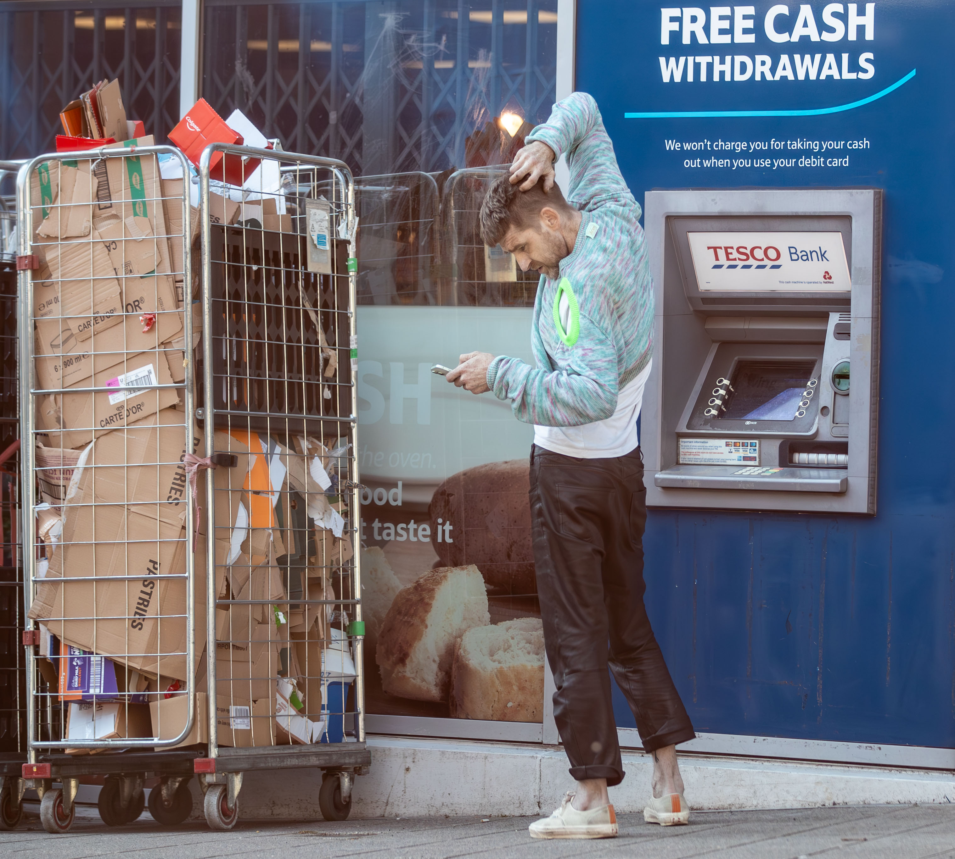 He pulled on a jersey and tapped on his phone as he headed to a cashpoint