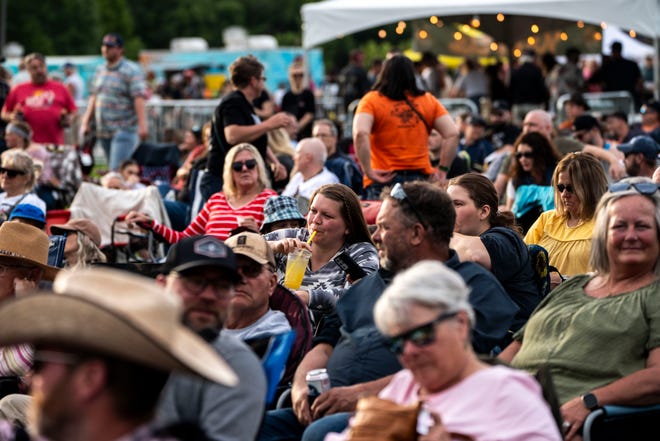 Audience members hang out before Willie Nelson and Family performs at Lauridsen Amphitheater at Water Works Park on Saturday, May 25, 2024, in Des Moines.