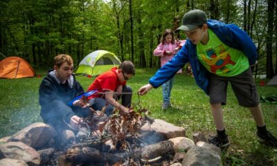 Left to right, Alexzander Burt, 16, Logan Pharris, 12, Violet Osantowske, 11, and Simon Osantowske, 11, work on building a fire at D Bar A Scout Ranch in Metamora on Saturday, May 21, 2022. The Troop 1402 camping trip was planned solely by the scouts and the parents sit on standby so scouts can practice planning, cooking, and wilderness skills.