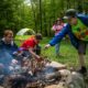 Left to right, Alexzander Burt, 16, Logan Pharris, 12, Violet Osantowske, 11, and Simon Osantowske, 11, work on building a fire at D Bar A Scout Ranch in Metamora on Saturday, May 21, 2022. The Troop 1402 camping trip was planned solely by the scouts and the parents sit on standby so scouts can practice planning, cooking, and wilderness skills.