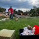 A man helps gather June Handsacker's porcelain dolls from the wreckage of her home.