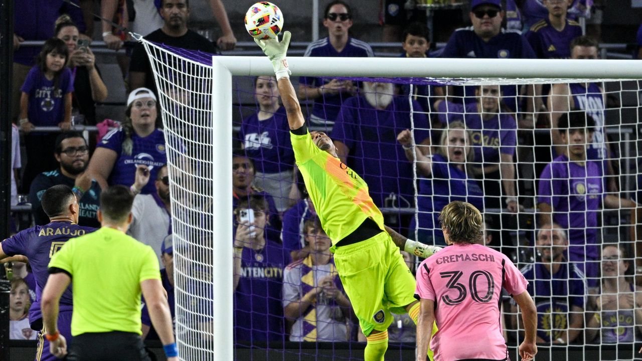 Orlando City goalkeeper Pedro Gallese, middle, makes a save as Inter Miami midfielder Benjamin Cremaschi (30) watches during the first half of an MLS soccer match Wednesday, May 15, 2024, in Orlando, Fla. (AP Photo/Phelan M. Ebenhack)