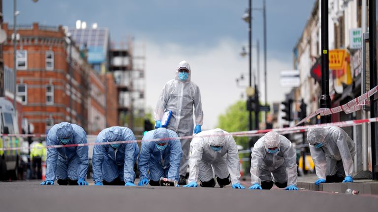 Police forensic officers on Kingsland High Street.
Pic PA