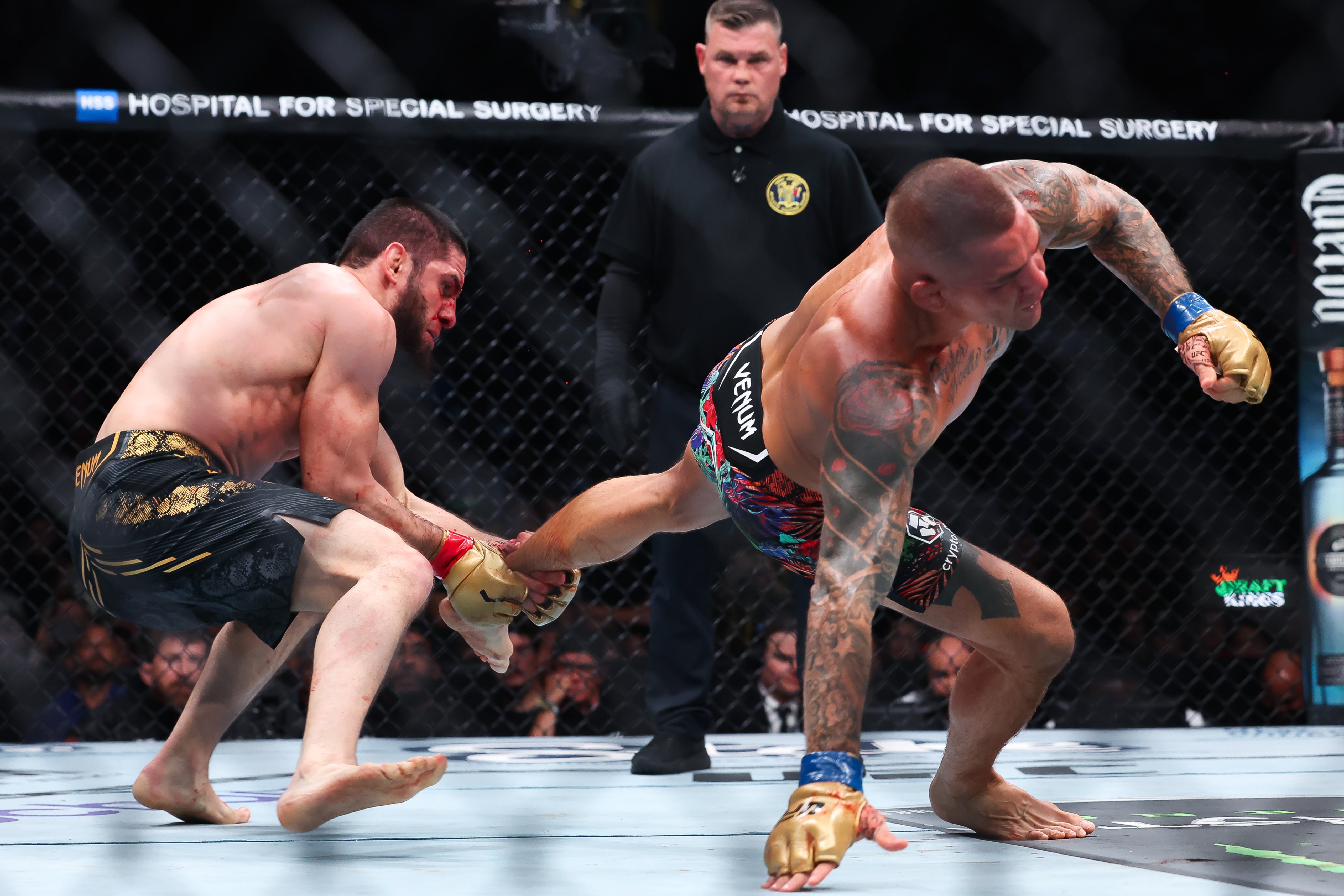 Islam Makhachev (left) used an ankle pick to set up the finish in round five