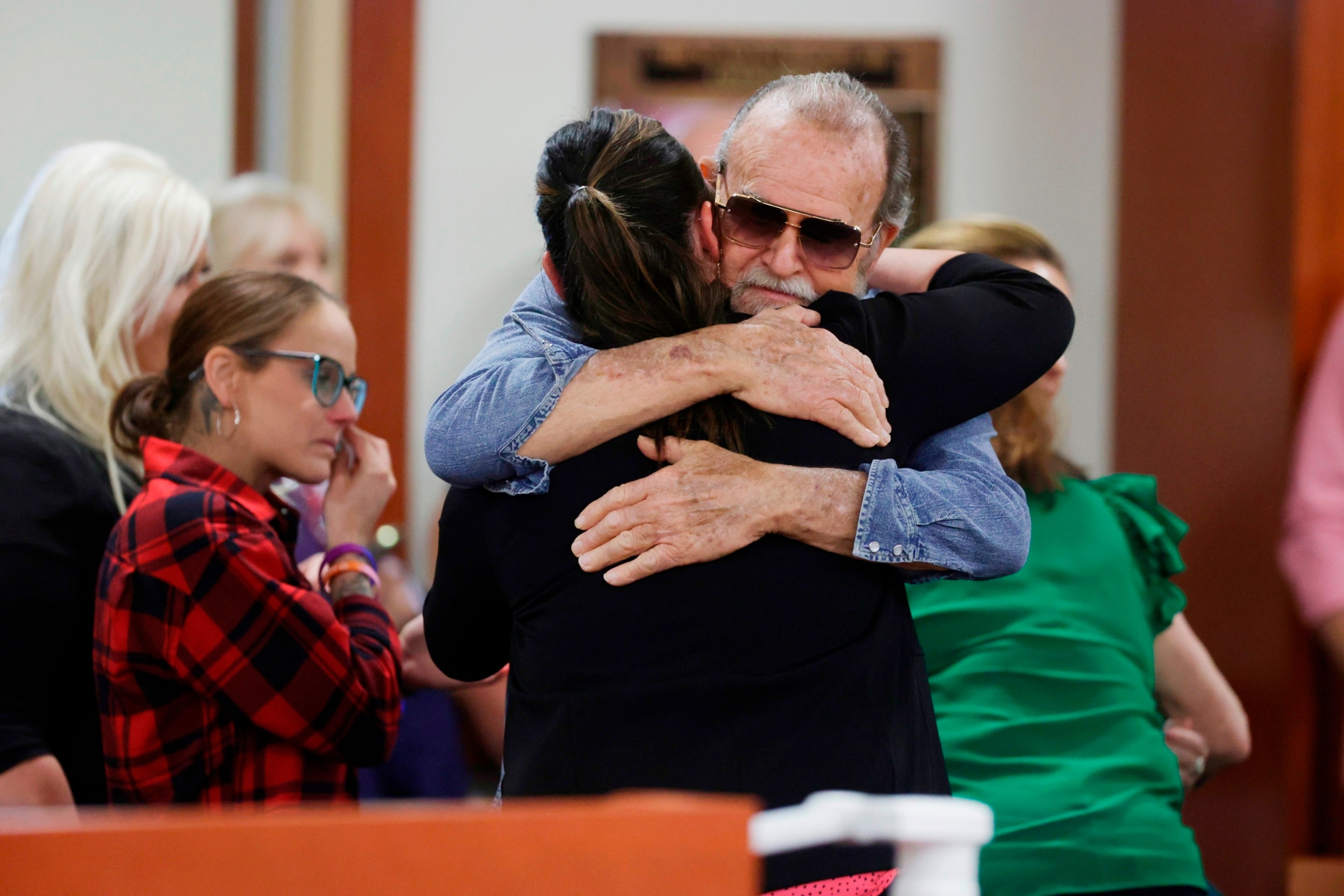 PHOTO: Larry Woodcock, gets a hug after the verdict in the Chad Daybell murder trial was read at the Ada County Courthouse in Boise, Idaho, on May 30, 2024. 