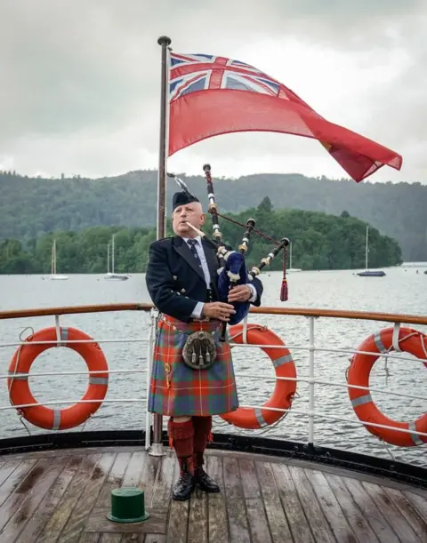 Danny Lawson/PA Media Lone bagpiper Richard Cowie