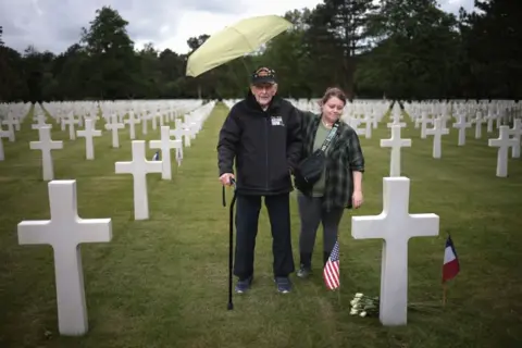 Win McNamee/Getty Images Gene Kleindl, from Rockford, Illinois, stands at the grave of his friend Ralph Gaddis