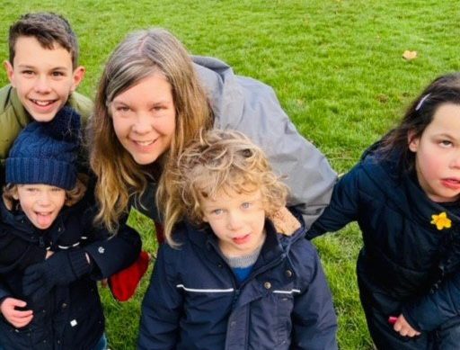 Kate with her kids at the park - all wearing warm coats