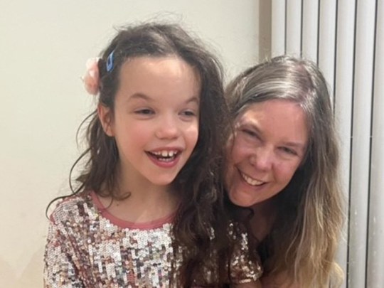 Kate with her daughter, who is wearing a sequinned dress