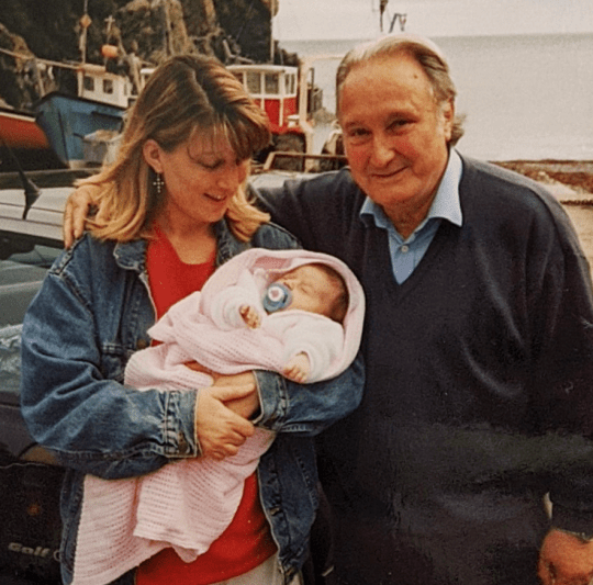 Mollie Quirk as a baby with mother and grandad