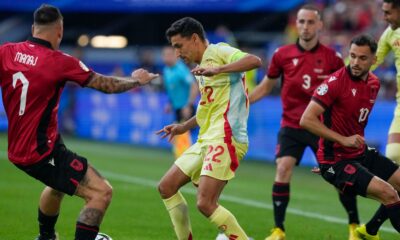 Spain's Jesus Navas, center, duels for the ball with Albania's Rey Manaj