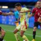 Spain's Jesus Navas, center, duels for the ball with Albania's Rey Manaj