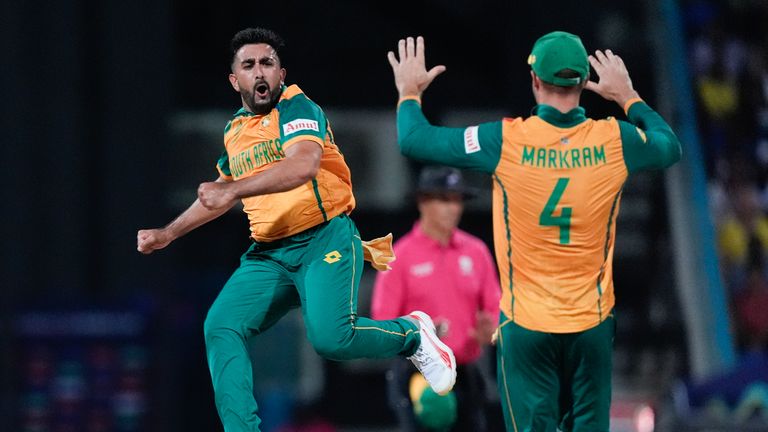 South Africa's Tabraiz Shamsi celebrates with teammate Aiden Markram after taking the wicket West Indies' Sherfane Rutherford during the ICC Men's T20 World Cup cricket match between the West Indies and South Africa at Sir Vivian Richards Stadium in North Sound, Antigua and Barbuda, Sunday, June 23, 2024. (AP Photo/Lynne Sladky)