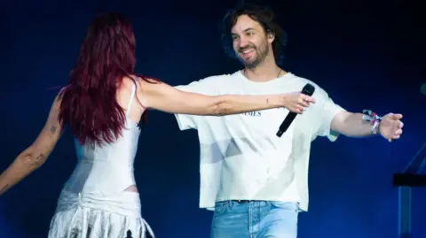 Getty Images Dua Lipa embracing Kevin Parker