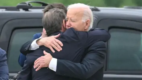 Getty Images Hunter and Joe Biden embrace on the tarmac in Delaware