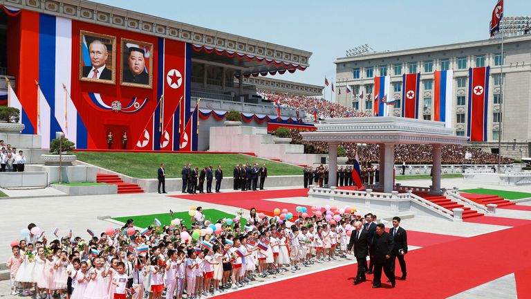 Vladimir Putin and Kim Jong Un attend an official welcoming ceremony at Kim Il Sung Square in Pyongyang, North Korea.
Pic:Sputnik/Reuters