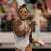 Simone Biles smiles during her floor exercise routine at the U.S. Gymnastics Championships on Sunday.