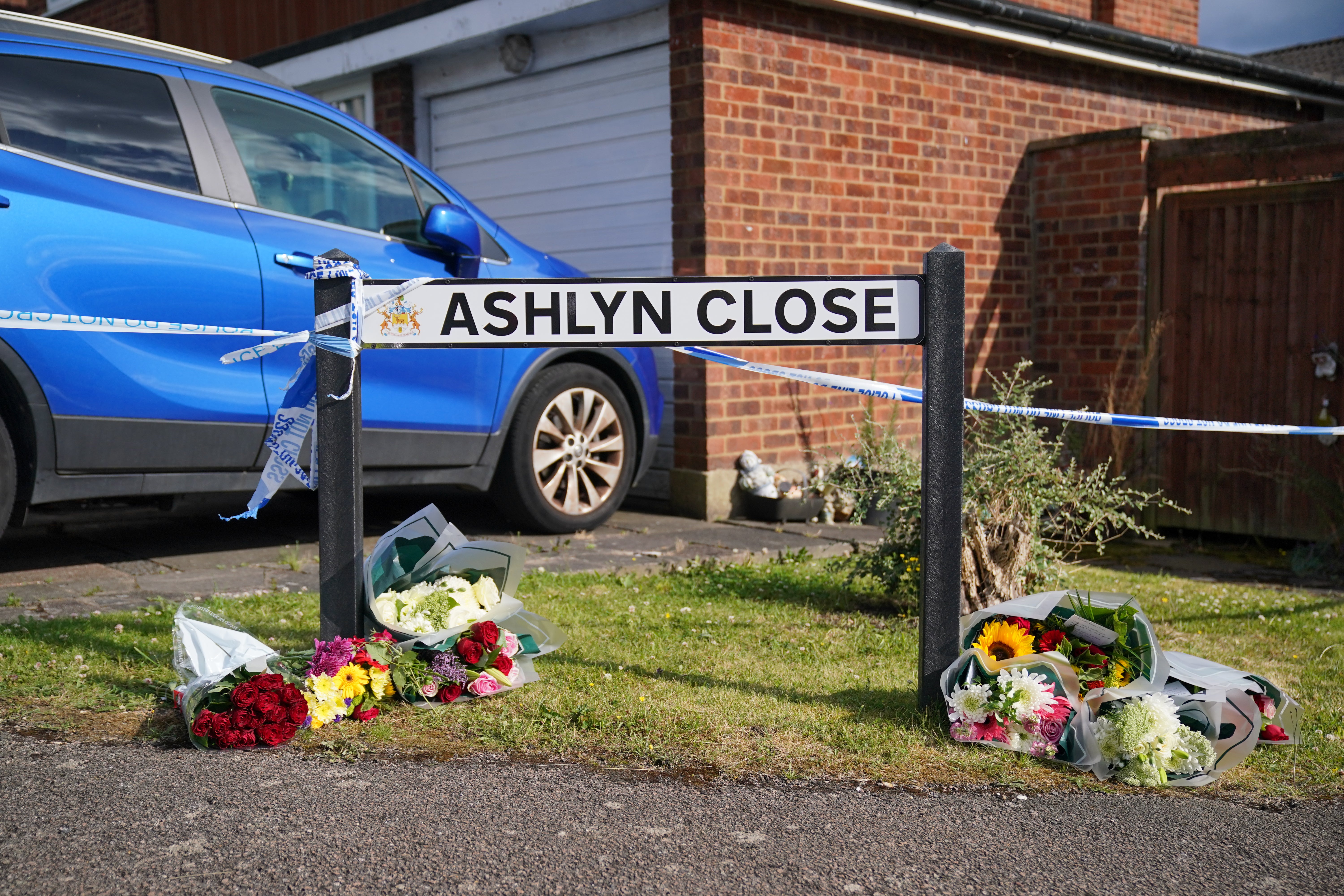 A view of the scene in Ashlyn Close where friends and neighbours laid floral tributes to the family